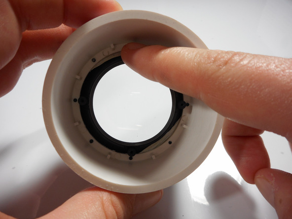 Image 1/2: The outer lens is now free and ready for replacement.