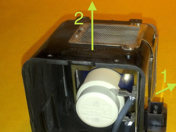 Image 3/3: Slightly pull the metal frame (1) and lift the housing top half (2) to reveal the bulb.